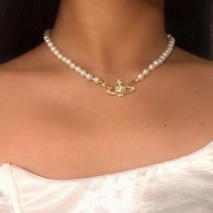 Gold pearl necklace with saturn planet charm